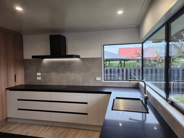 Grey large-format tile kitchen splashback wider view