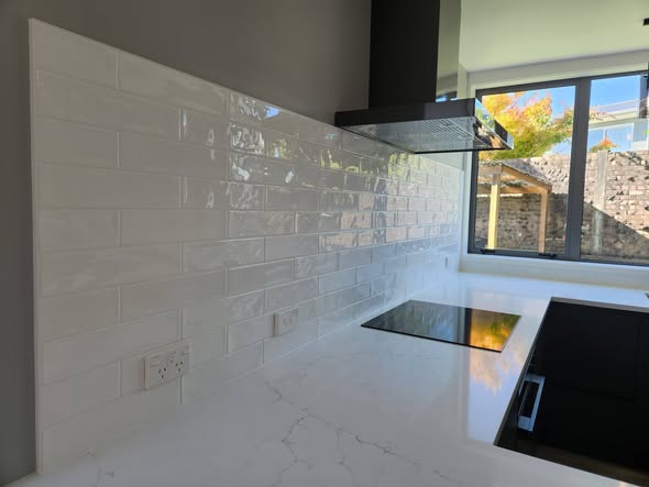 White glossy subway with window and induction hob